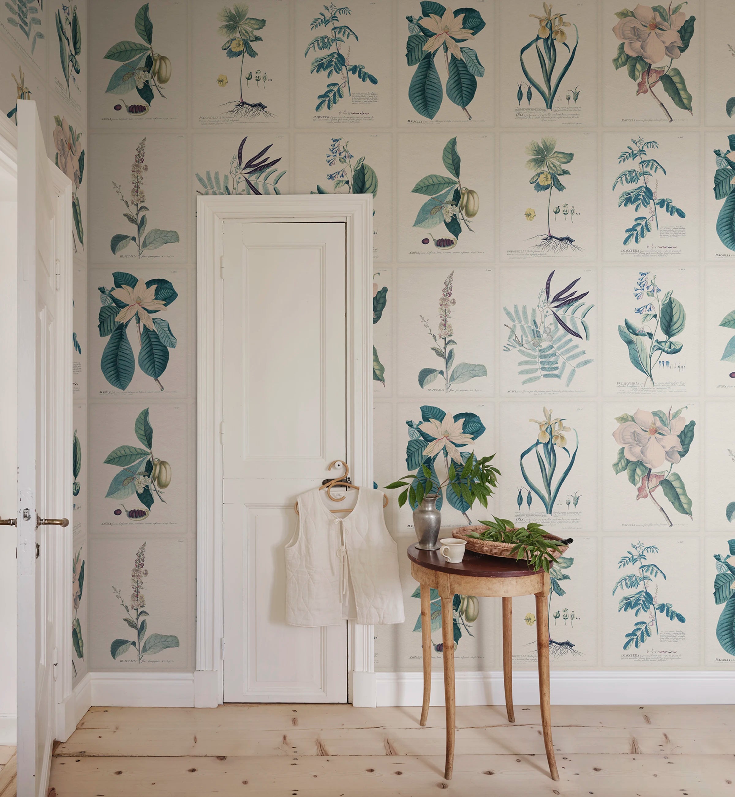 Flora wallpaper by Sandberg – botanical design, Blue, styled on an interior wall