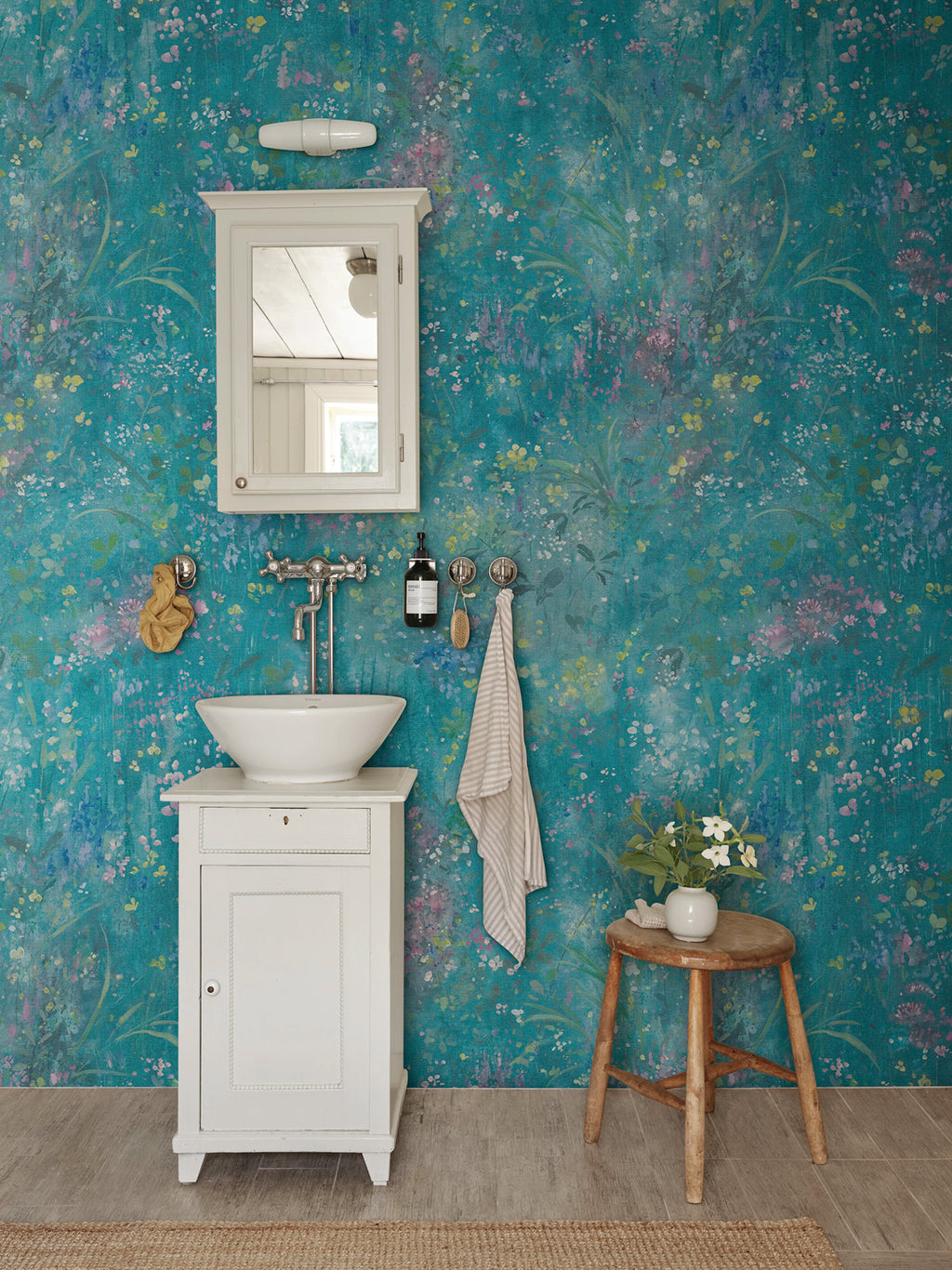 Juni wallpaper by Sandberg – floral design, Teal, styled on an interior wall