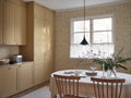 Tree of Life wallpaper by Sandberg in ochre-gold, styled in a kitchen-diner beside a window with timber table and chairs