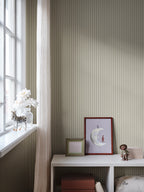 Estelle wallpaper by Sandberg in Light Green, styled on an interior wall
