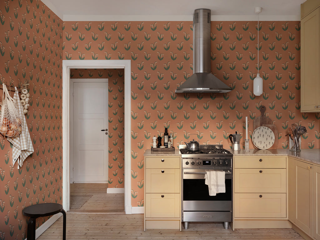Lilly wallpaper by Sandberg in Terracotta, styled on an interior wall
