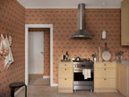 Lilly wallpaper by Sandberg in Terracotta, styled on an interior wall