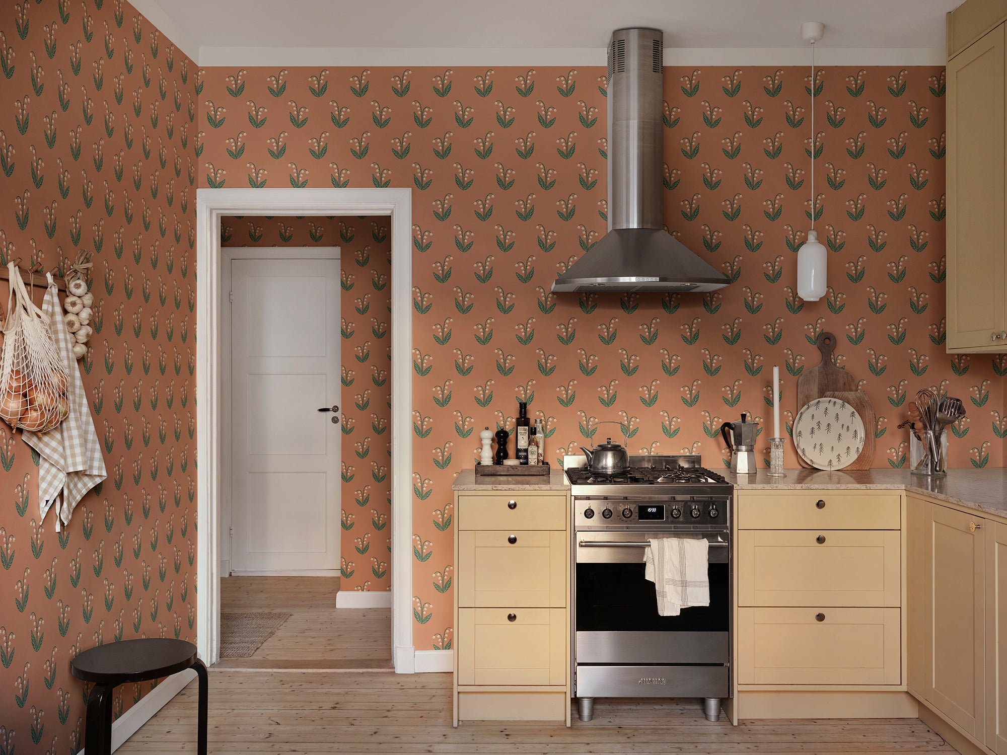 Lilly wallpaper by Sandberg in Terracotta, styled on an interior wall