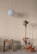 Hollie wallpaper by Sandberg in dusky pink woodland print in a hallway with wooden stool and rattan coat stand