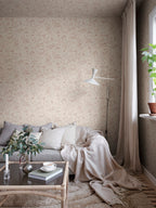 Hollie wallpaper by Sandberg in blush pink woodland print in a snug living room corner with grey sofa