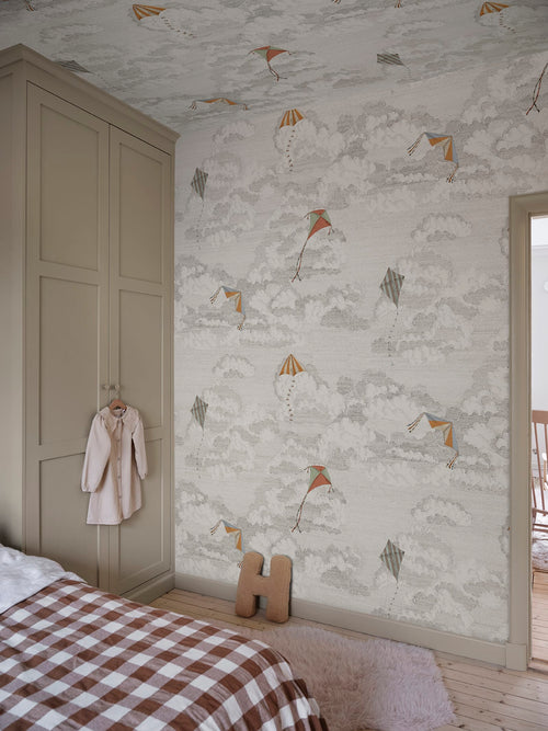 Bonnie & Kites wall mural by Sandberg in cream behind a wavy mirror in a childs room with wooden toys