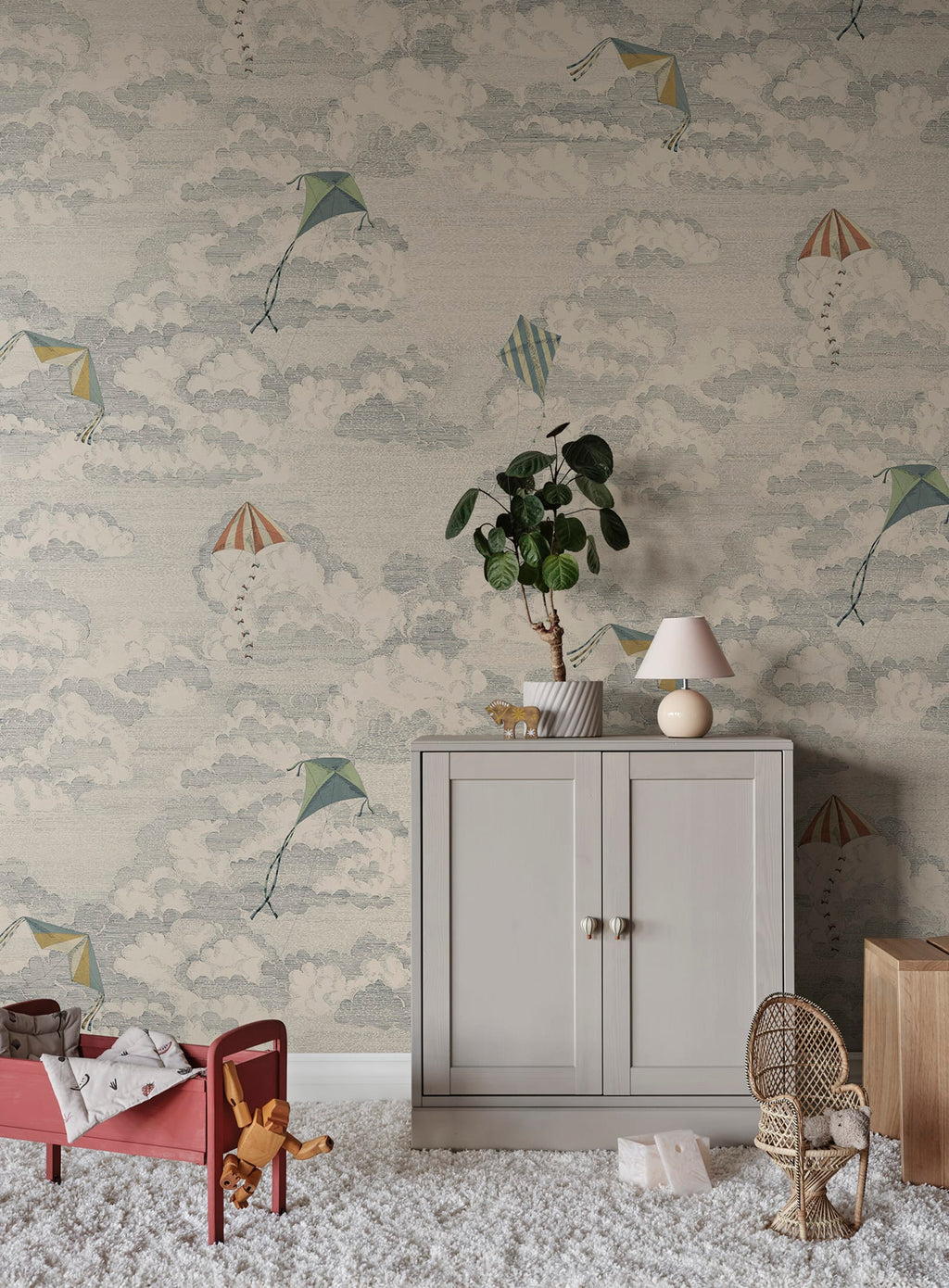 Bonnie & Kites wall mural by Sandberg in blue-grey styled in a childs room with a cabinet and rattan chair