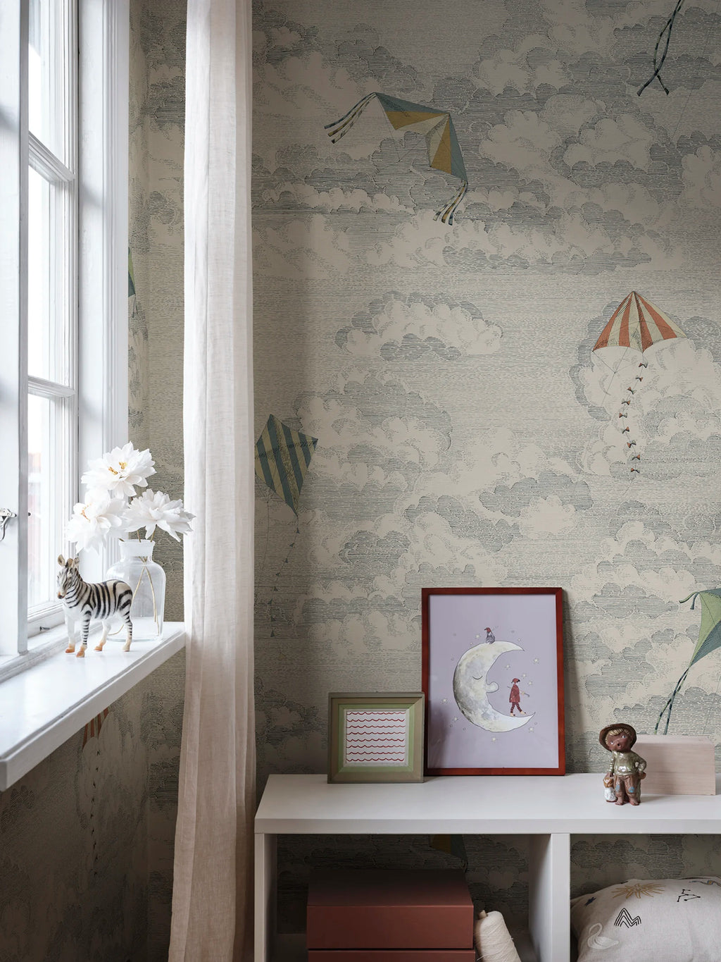 Bonnie & Kites wall mural by Sandberg in blue-grey styled in a nursery beside a window with a zebra figurine