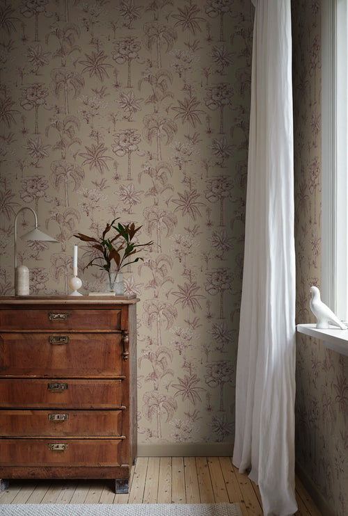 Adele palm toile wallpaper by Sandberg in sand in a sunlit corner with an antique chest and bird ornament