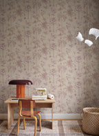 Adele palm toile wallpaper by Sandberg in sand behind a small desk with a sewing machine and mushroom lamp
