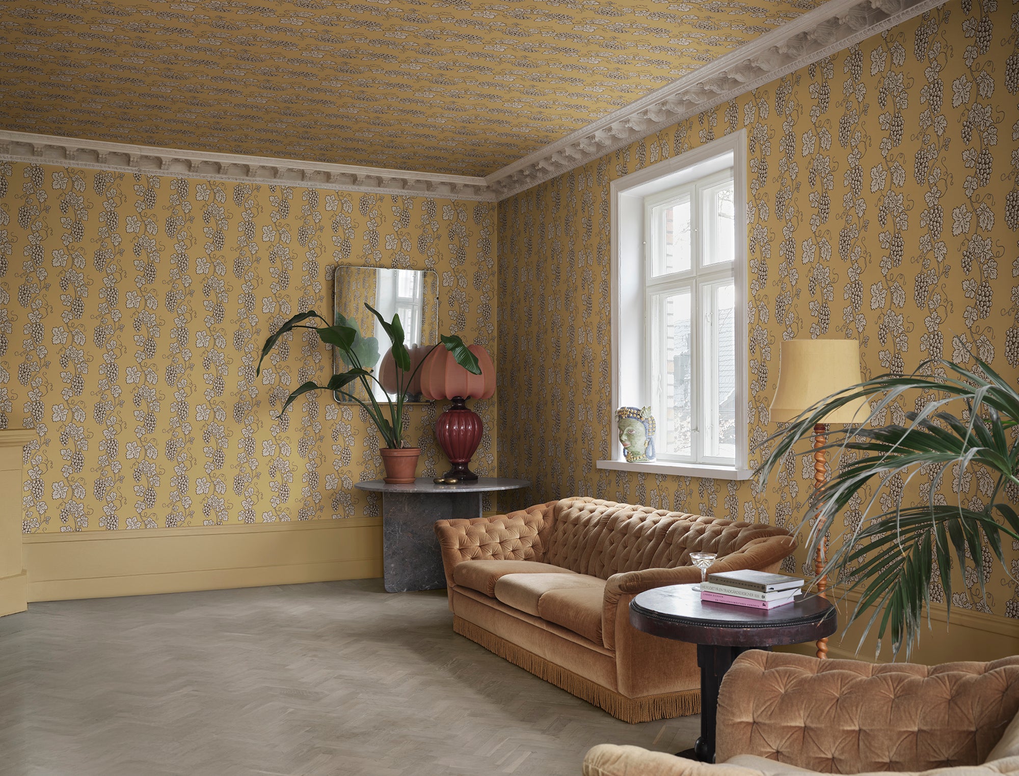 Carla wallpaper by Sandberg in Honey, styled on an interior wall