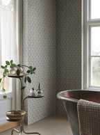 Elena blue floral wallpaper by Sandberg in a bathroom corner, metal copper tub by a window with a trailing plant on a side stand