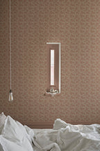 Coral wallpaper by Sandberg in warm clay, styled in a bedroom with a recessed window and rumpled white bedding
