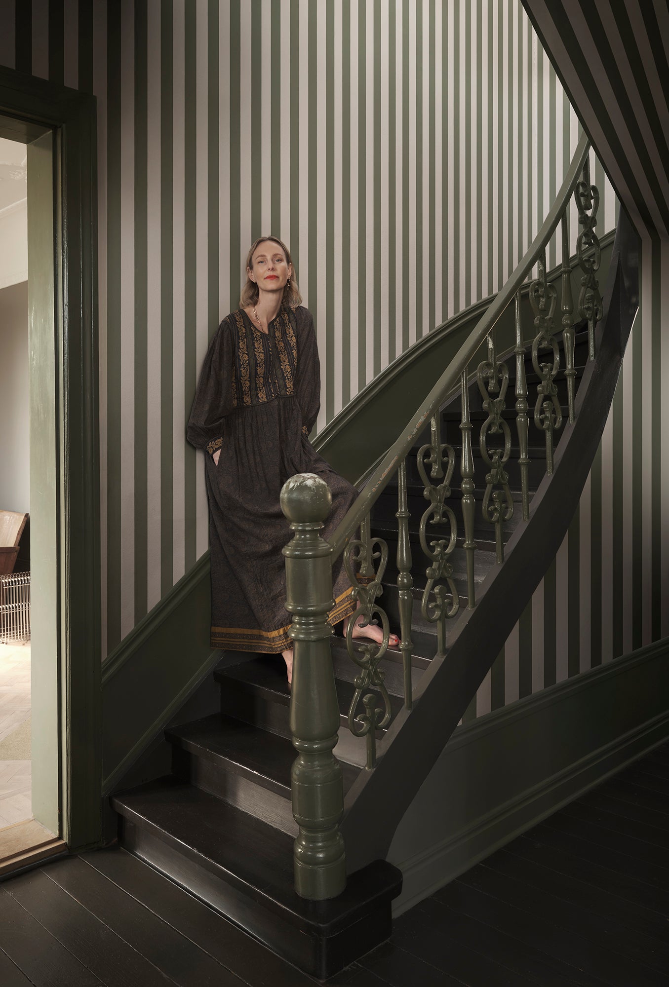 Sam wallpaper by Sandberg in Forest Green, styled on an interior wall