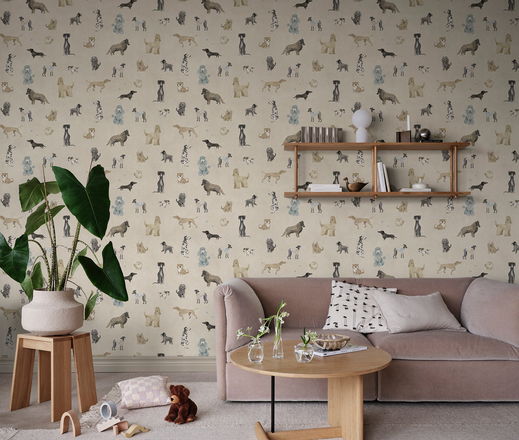 Taiga Dogs & Friends wall mural by Sandberg in sand beige styled in a living room with a pink sofa and wall shelf