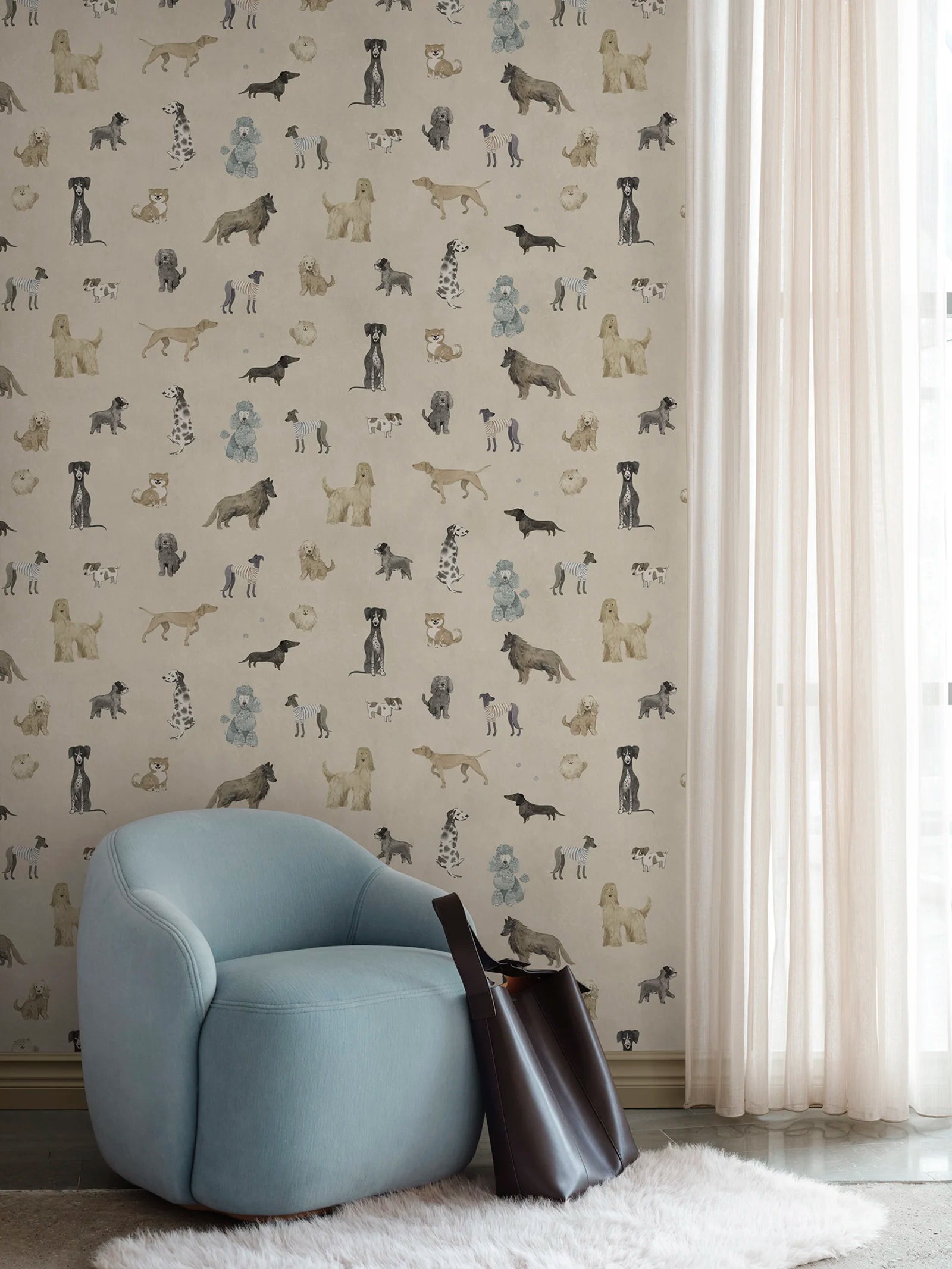Taiga Dogs & Friends wall mural by Sandberg in sand beige, watercolour dogs styled behind a pale blue armchair