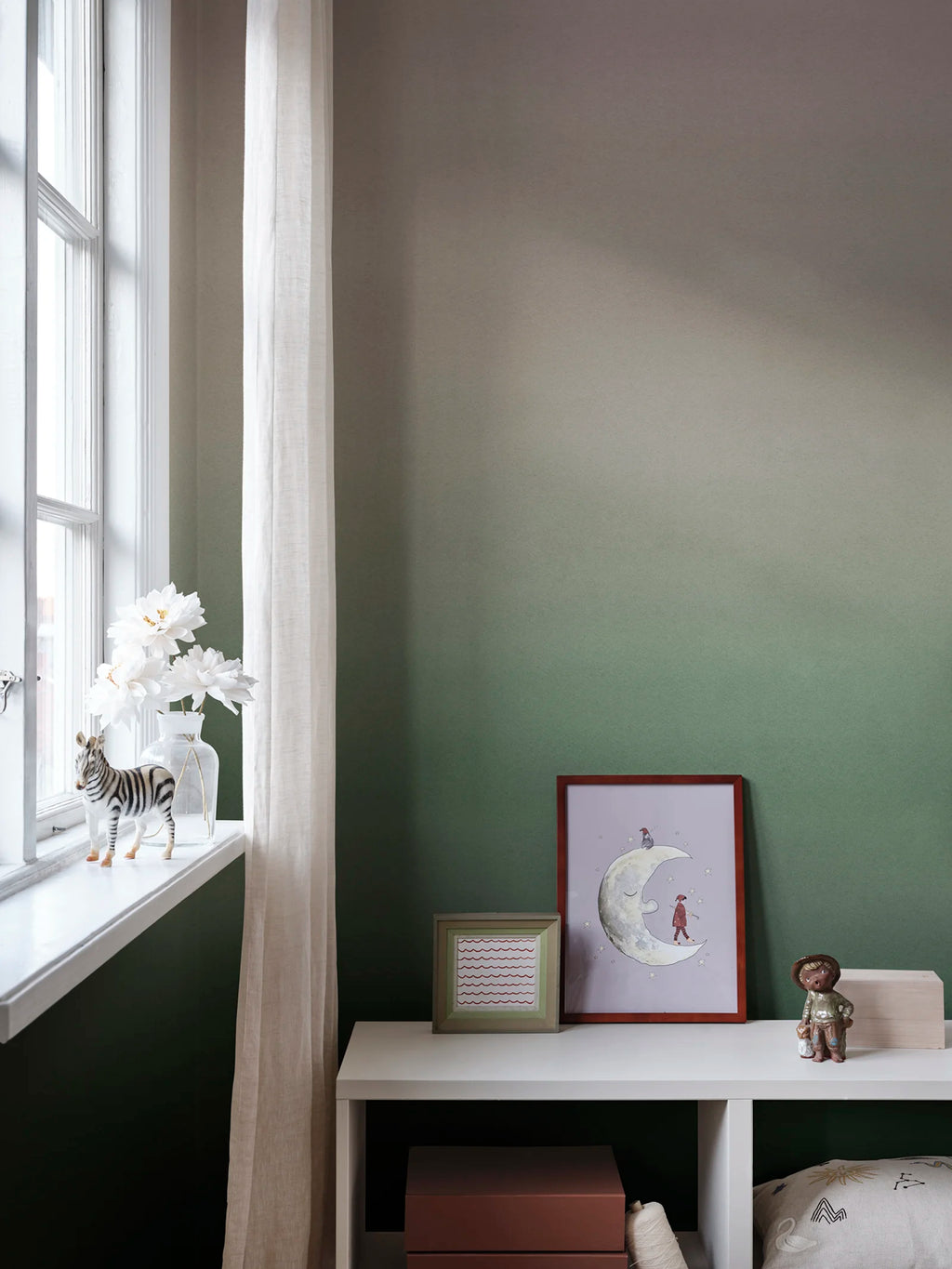 Skymning wall mural by Sandberg, sage green ombré sky styled in a childs room by a window with a moon print and toys
