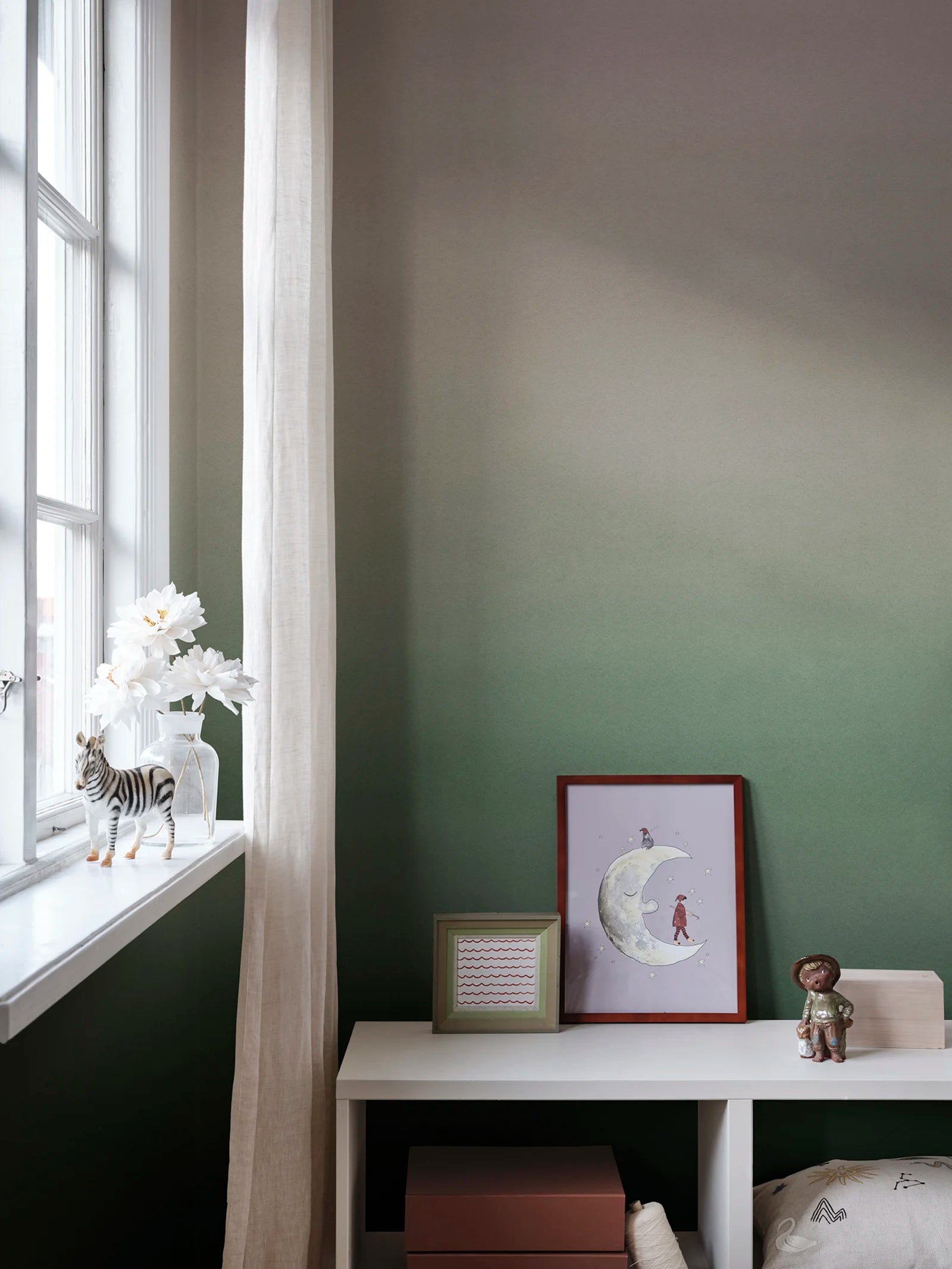 Skymning wall mural by Sandberg, sage green ombré sky styled in a childs room by a window with a moon print and toys