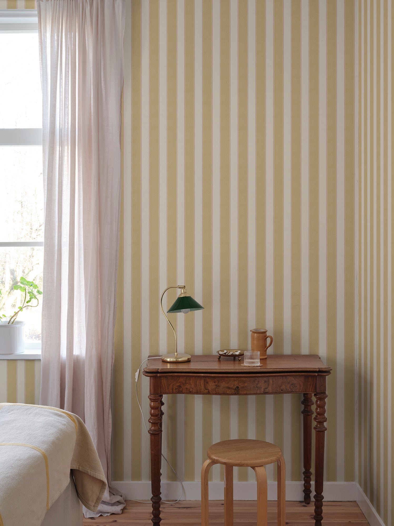 Henrik wallpaper by Sandberg in Yellow, styled on an interior wall