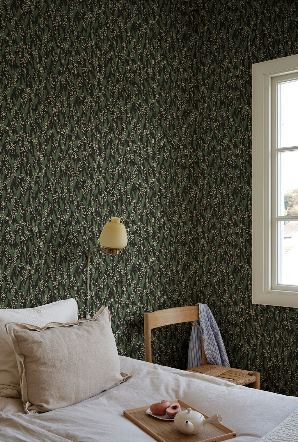 Liljekonvalj wallpaper by Sandberg in Charcoal, styled on an interior wall