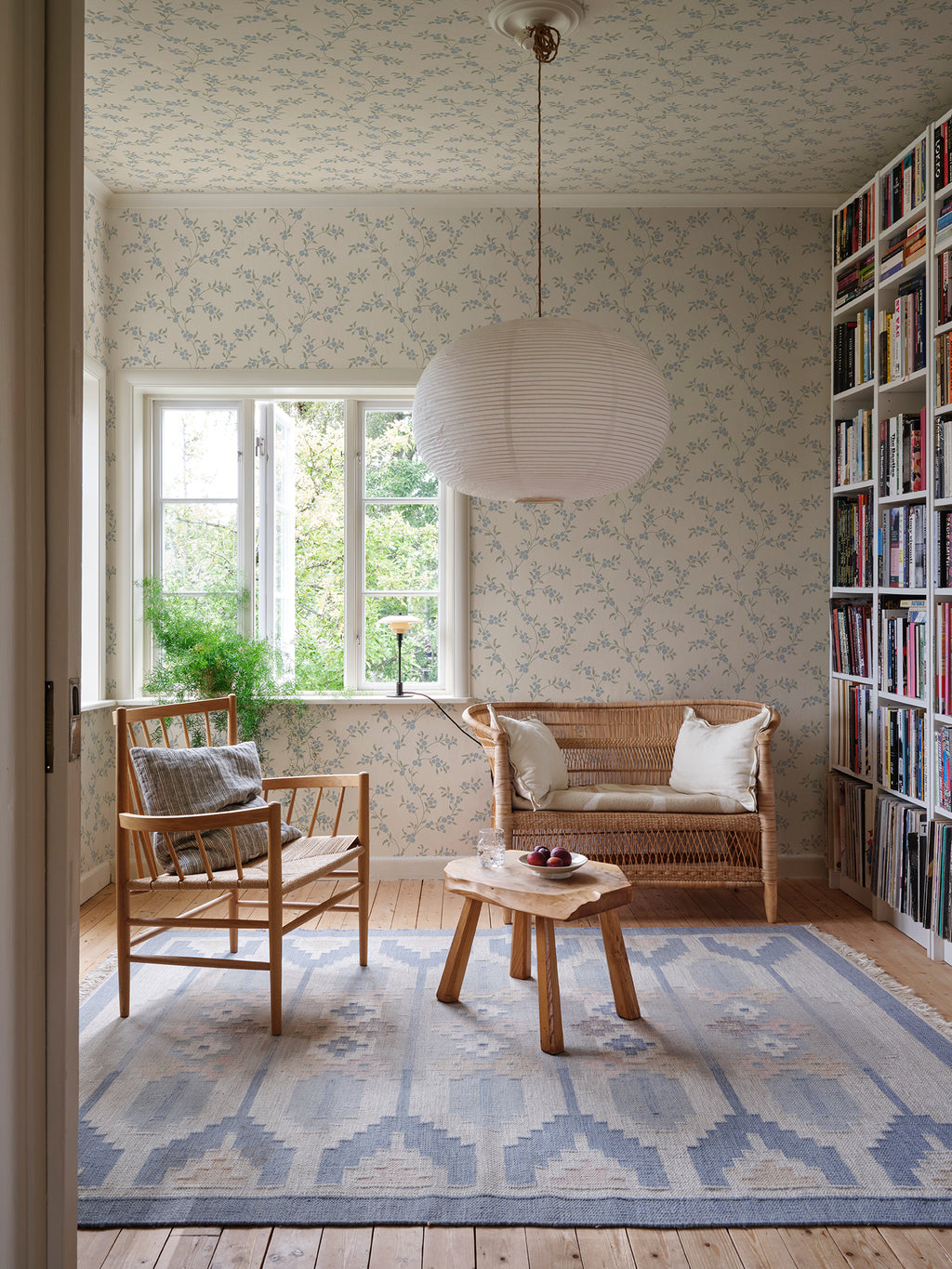 Smilli wallpaper by Sandberg in Misty Blue, styled on an interior wall