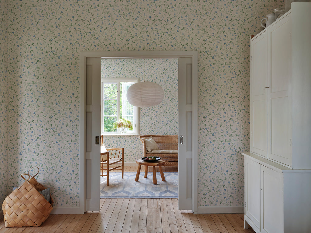 Lucy wallpaper by Sandberg in Sky Blue, styled on an interior wall