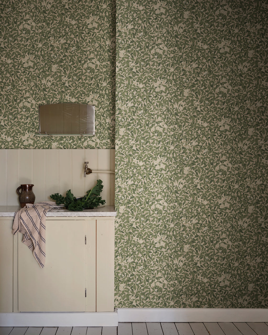 Linnea wallpaper by Sandberg in Forest Green, styled on an interior wall
