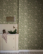 Linnea wallpaper by Sandberg in Forest Green, styled on an interior wall