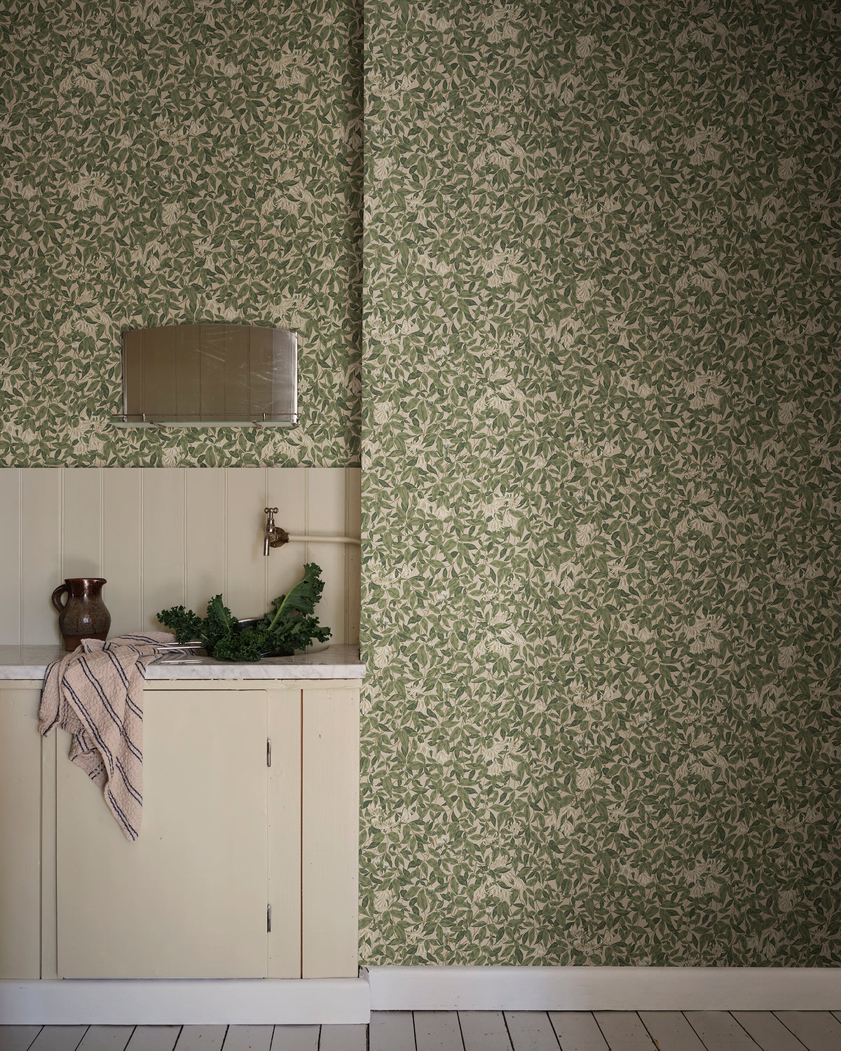 Linnea wallpaper by Sandberg in Forest Green, styled on an interior wall