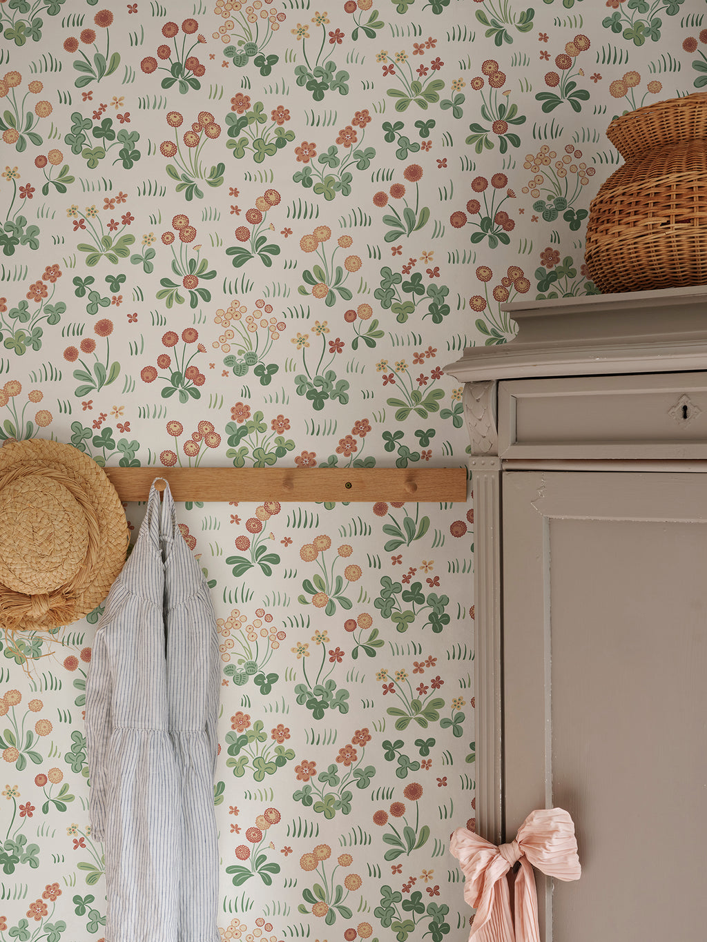 Bellis wallpaper by Sandberg in Red, styled on an interior wall