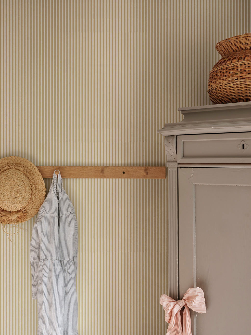 Fabian wallpaper by Sandberg in Honey, styled on an interior wall
