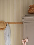 Fabian wallpaper by Sandberg in Honey, styled on an interior wall