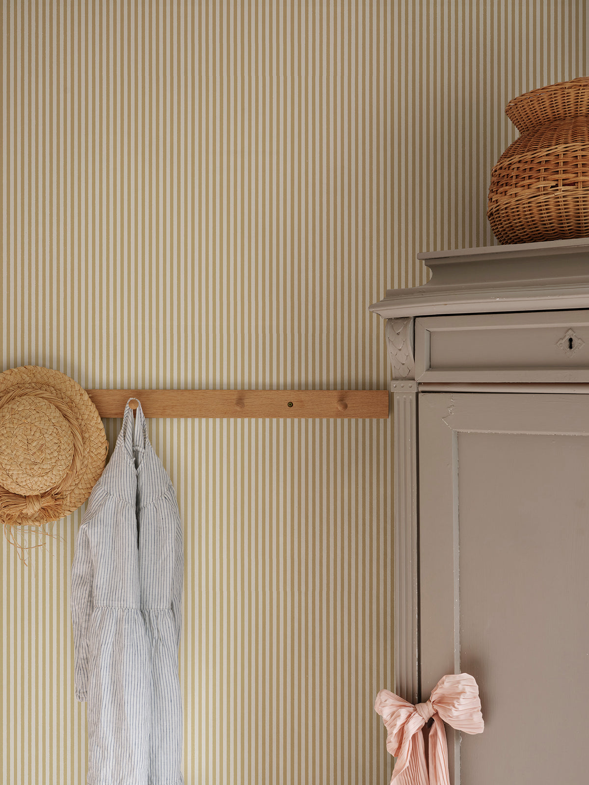 Fabian wallpaper by Sandberg in Honey, styled on an interior wall