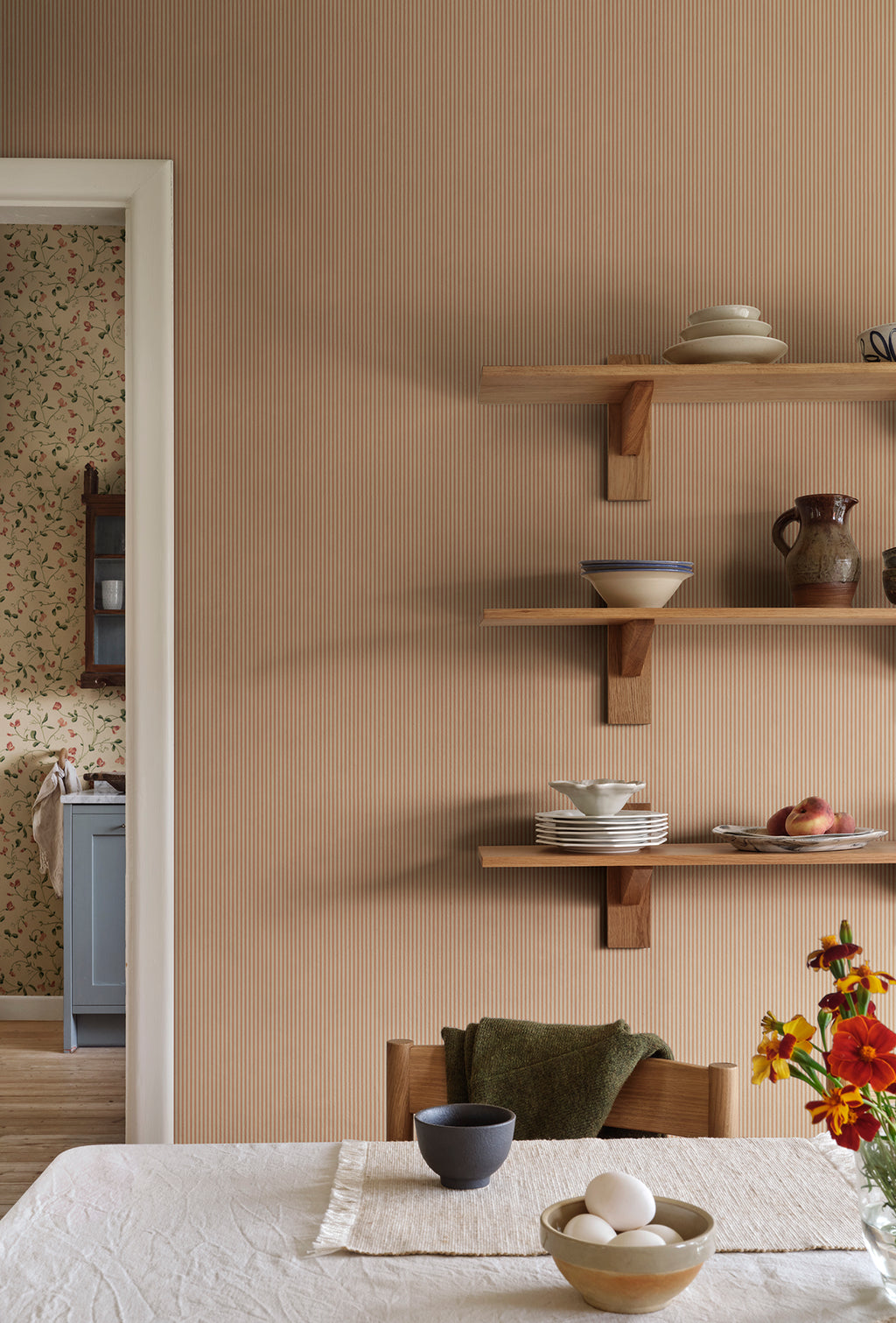 Fabian wallpaper by Sandberg in Terracotta, styled on an interior wall