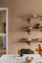 Fabian wallpaper by Sandberg in Terracotta, styled on an interior wall