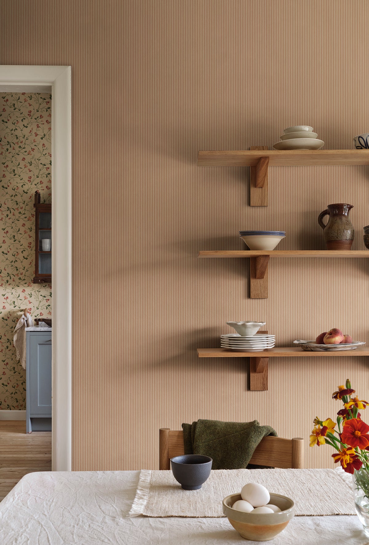 Fabian wallpaper by Sandberg in Terracotta, styled on an interior wall