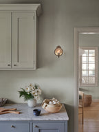 Fabian wallpaper by Sandberg in Misty Blue, styled on an interior wall