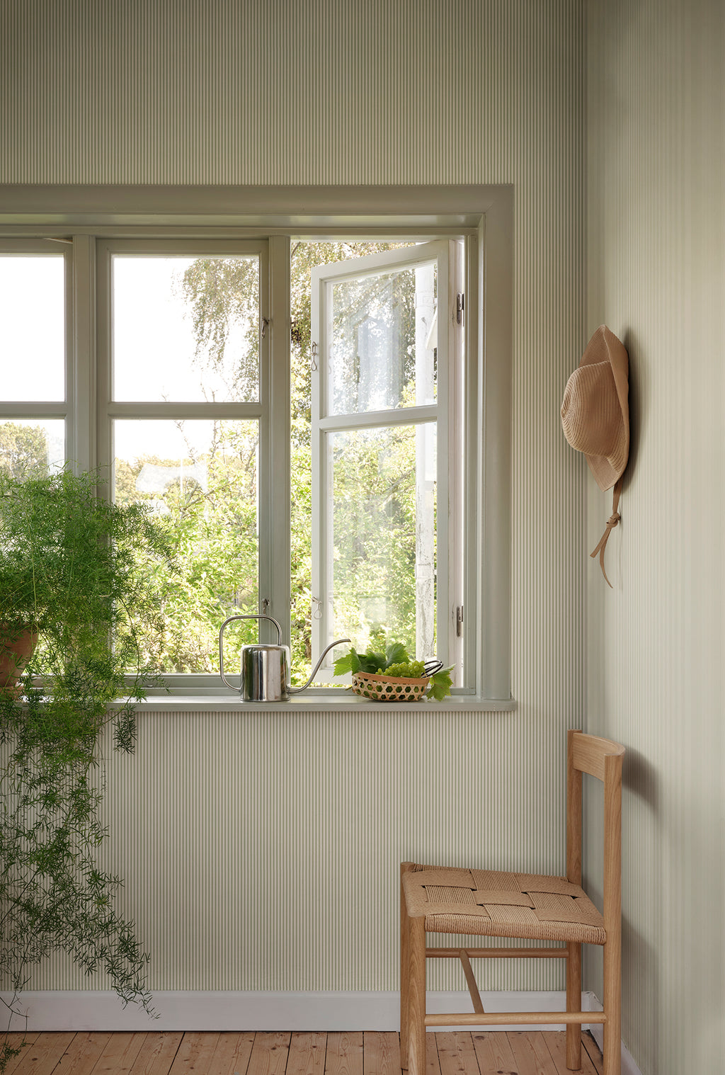 Fabian wallpaper by Sandberg in Garden Green, styled on an interior wall
