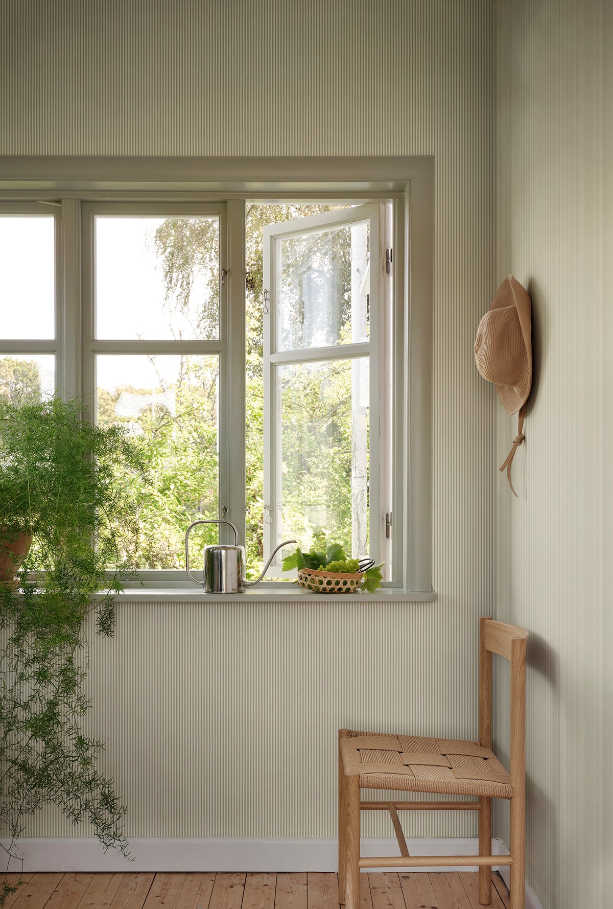 Fabian wallpaper by Sandberg in Garden Green, styled on an interior wall