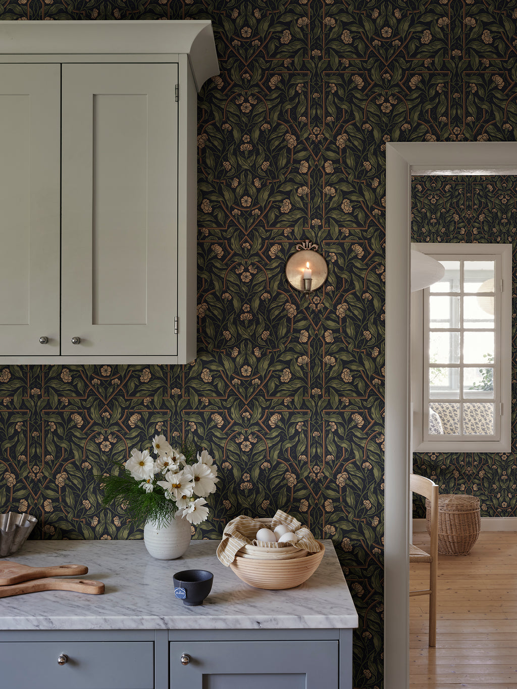 Edda wallpaper by Sandberg in Classic Blue, styled on an interior wall