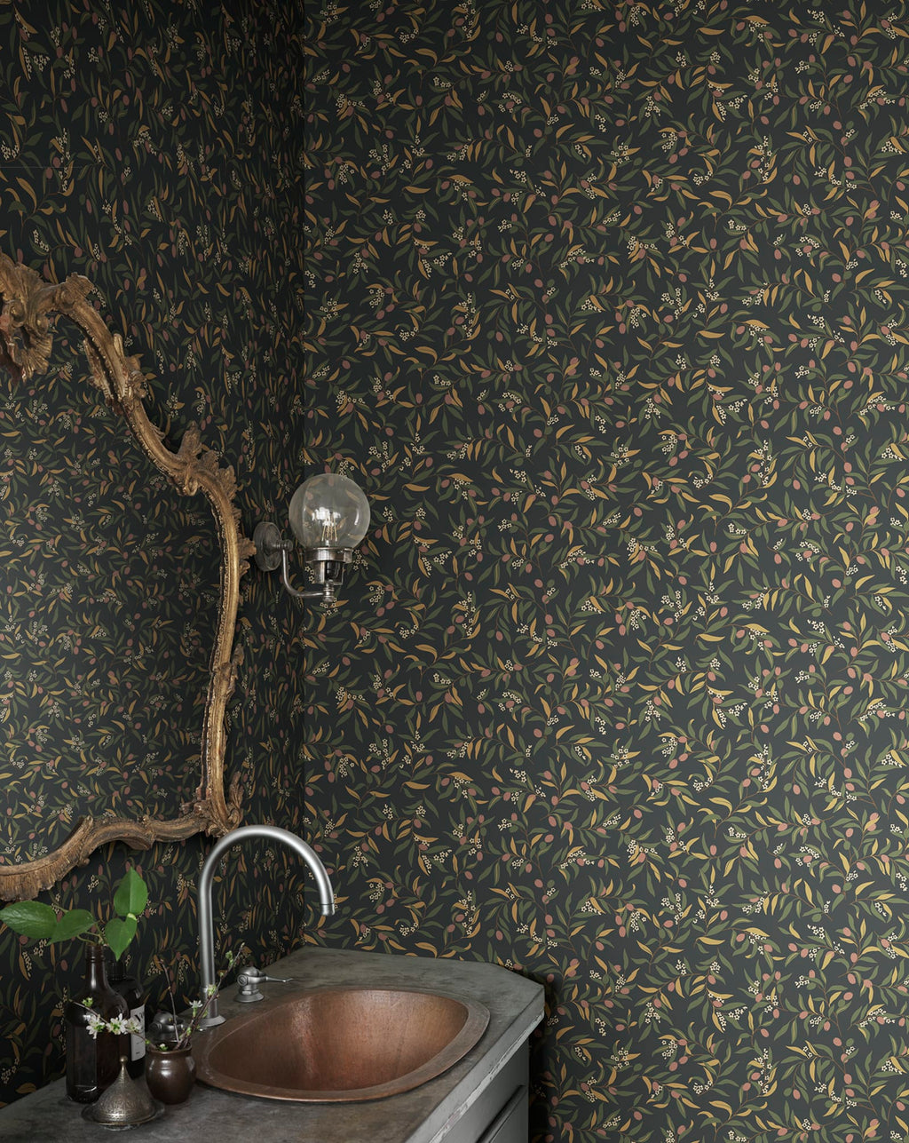 Olivia wallpaper by Sandberg in olive sprigs on charcoal black, styled in a powder room with copper basin and ornate gold mirror