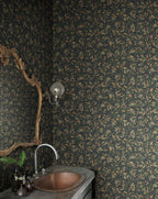 Olivia wallpaper by Sandberg in olive sprigs on charcoal black, styled in a powder room with copper basin and ornate gold mirror