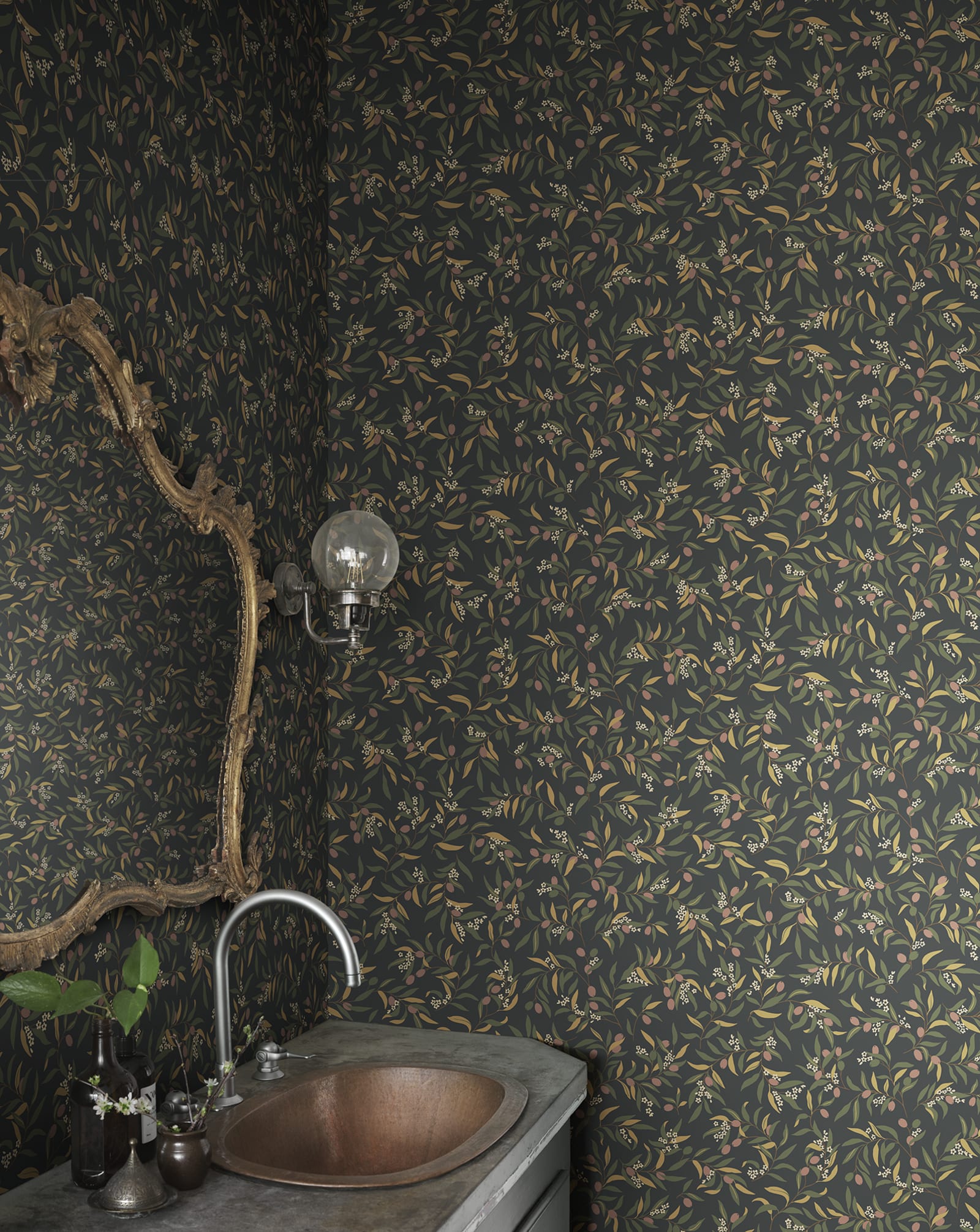 Olivia wallpaper by Sandberg in olive sprigs on charcoal black, styled in a powder room with copper basin and ornate gold mirror