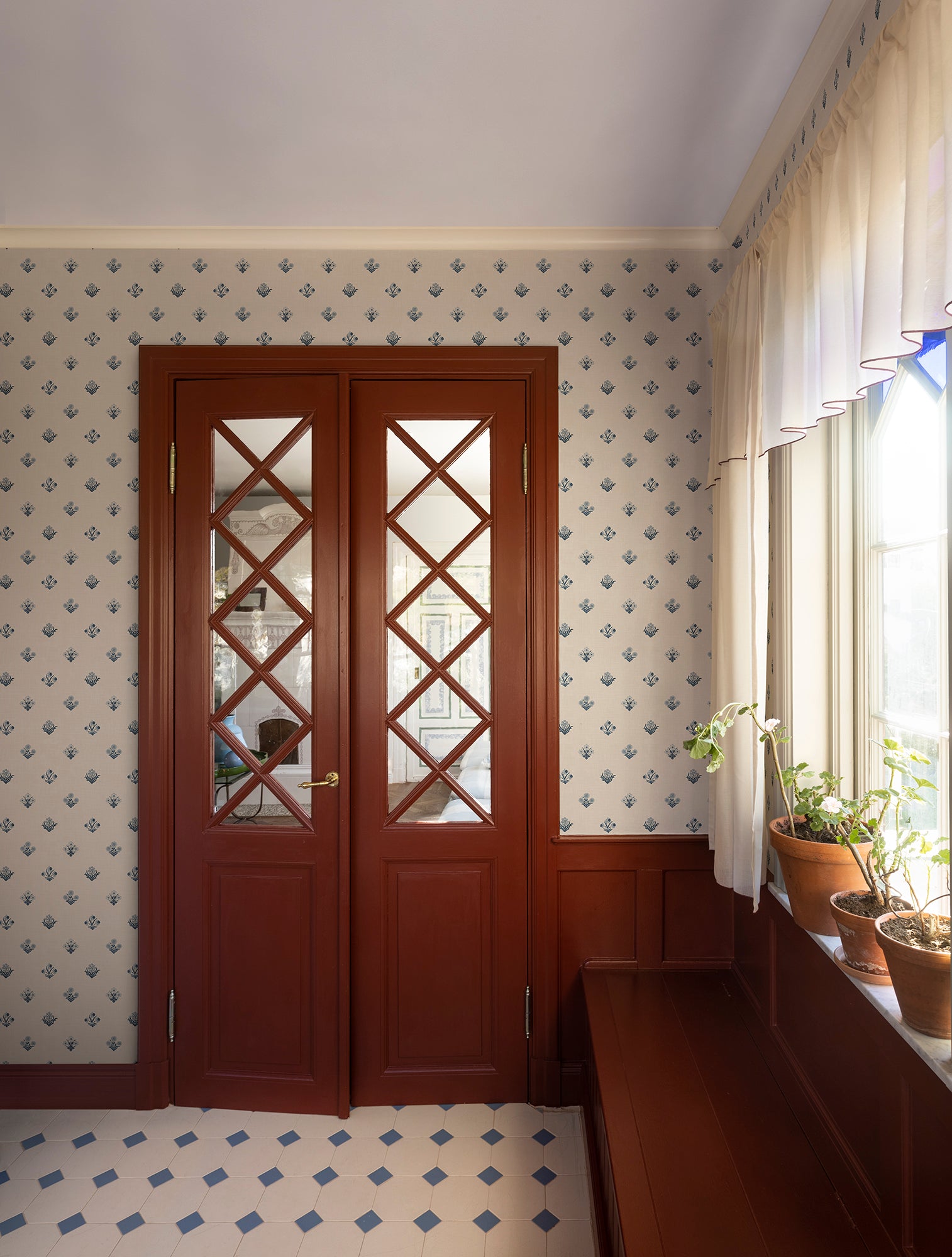 Amy wallpaper by Sandberg in blue framing terracotta double doors with diamond glazing and potted plants