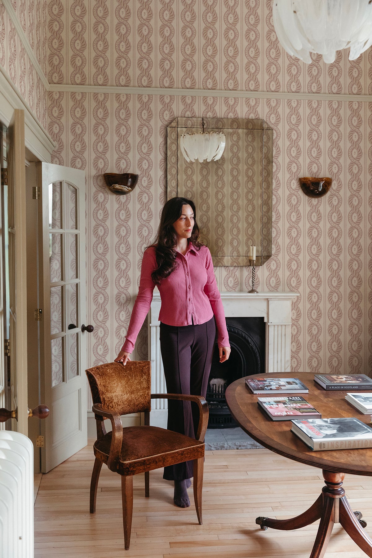 Emilion wallpaper by Sandberg in Red in a sitting room with a mirror, fireplace and round table