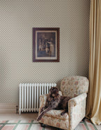 Elise wallpaper by Sandberg in Green beside an armchair and radiator with a framed print