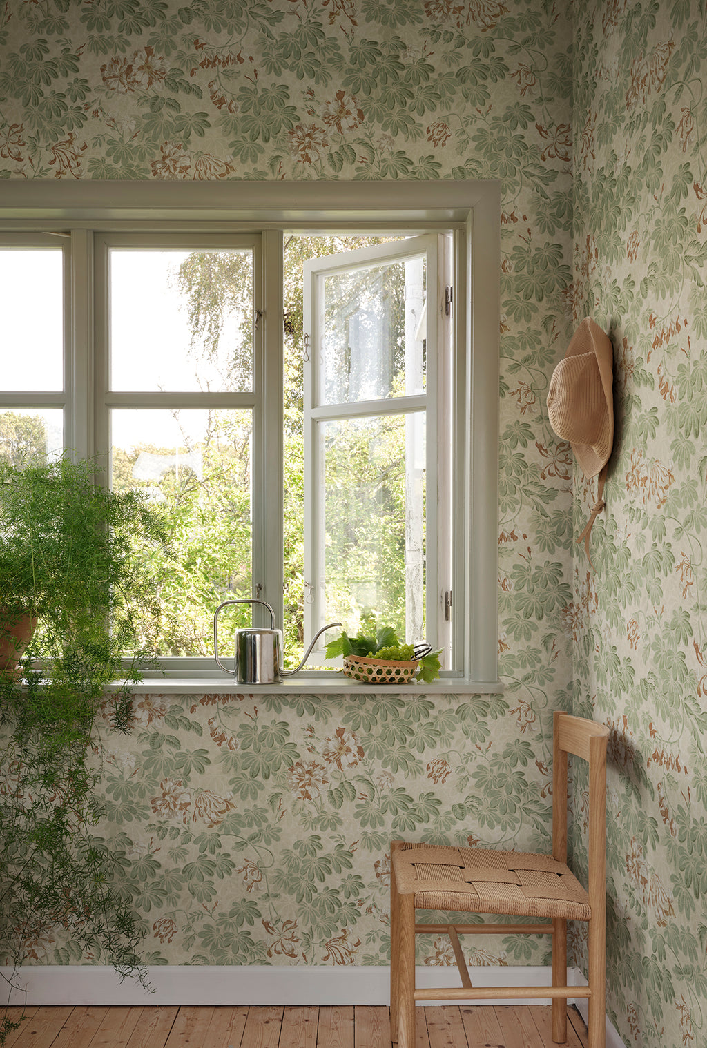 Tyra wallpaper by Sandberg in Garden Green, styled on an interior wall