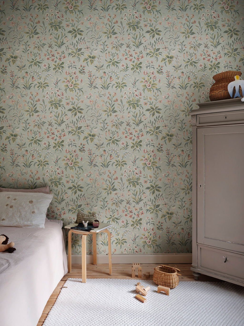 Ania wallpaper by Sandberg in Misty Blue, styled on an interior wall