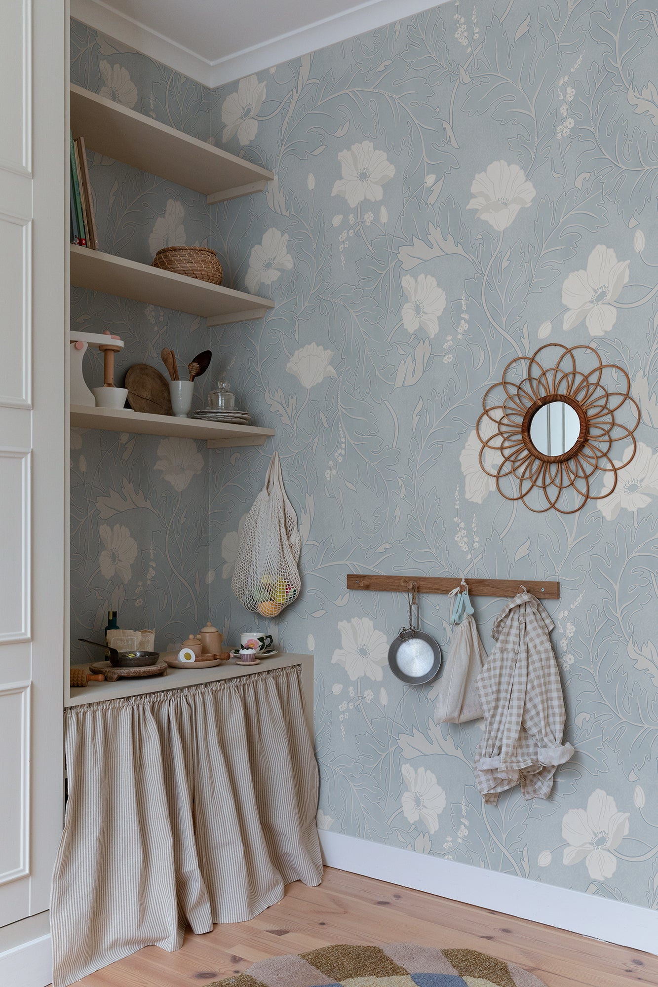 Poppy wallpaper by Sandberg in Light Blue, styled on an interior wall