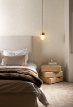 Kona wallpaper by Arte in Cream in a bedroom with a pendant light